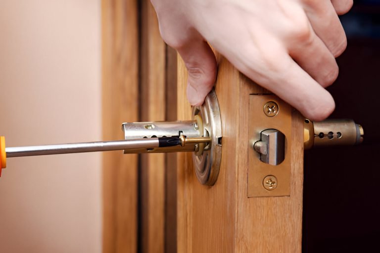 Locksmith repairing a forced front door after a break-in in North London