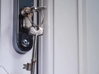 Locksmith adjusting a uPVC front door that has dropped on its hinges in North London